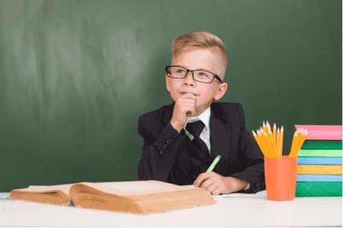 Pensive child student wearing a suit
